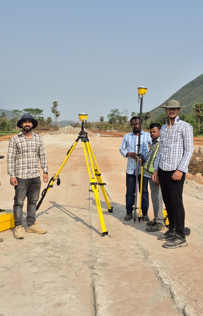 Survey team using Trimble GNSS receivers for RTK surveying, control point establishment, and site positioning at a construction project site.