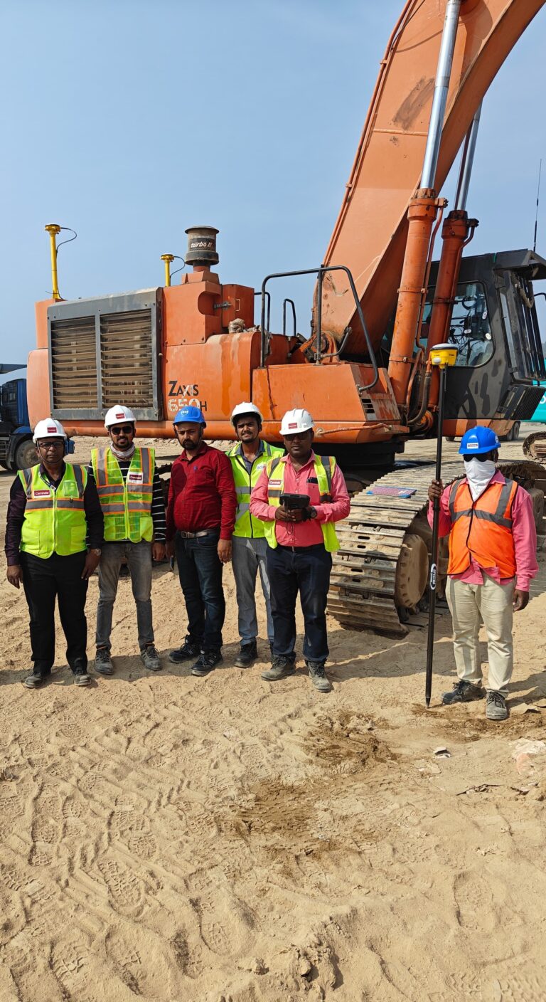 Survey team using Trimble GNSS equipment for machine control setup, site positioning, and construction surveying at an earthmoving project site.