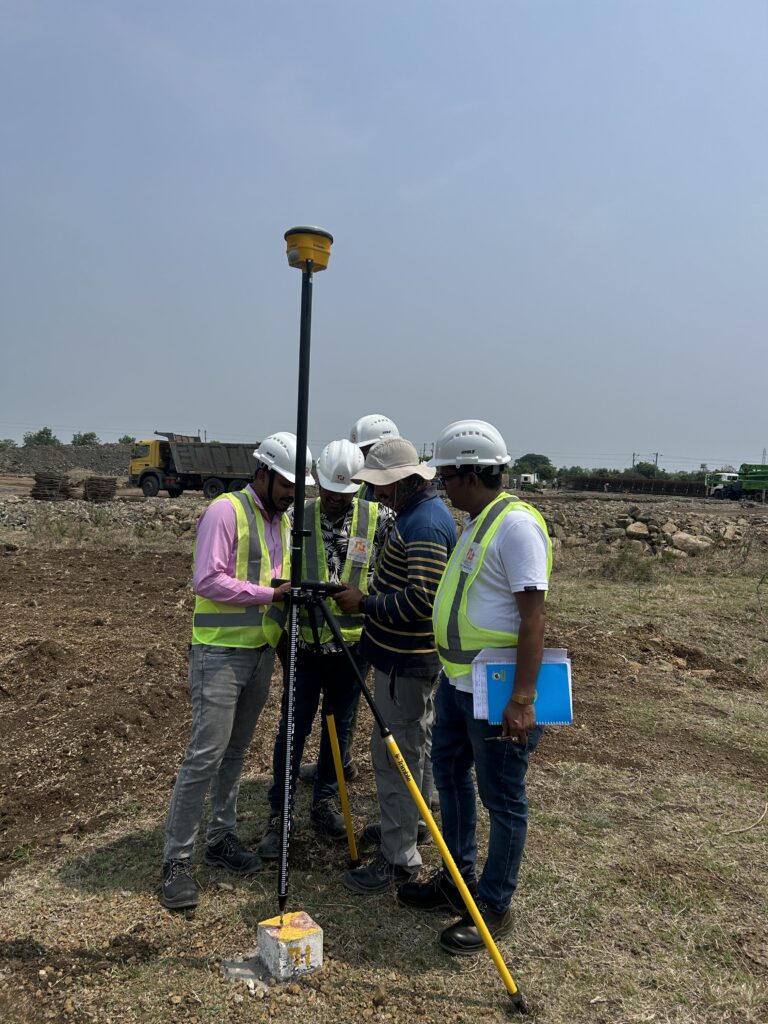 GNSS surveying equipment being used by surveyors at a construction site
