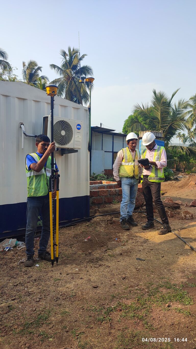Survey engineers using Trimble GNSS equipment for RTK surveying and site positioning at a project site in India.